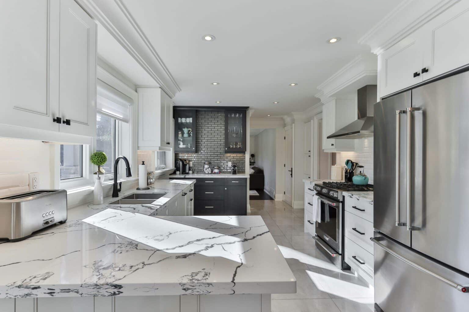 Gray kitchen with an L-shaped countertop and modern appliances.