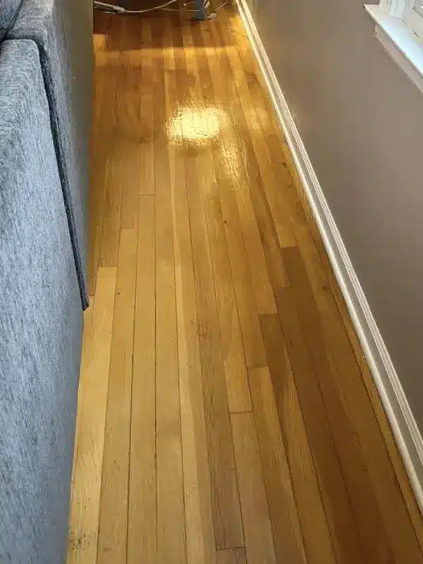 The same hardwood floor clear and shining after deep cleaning