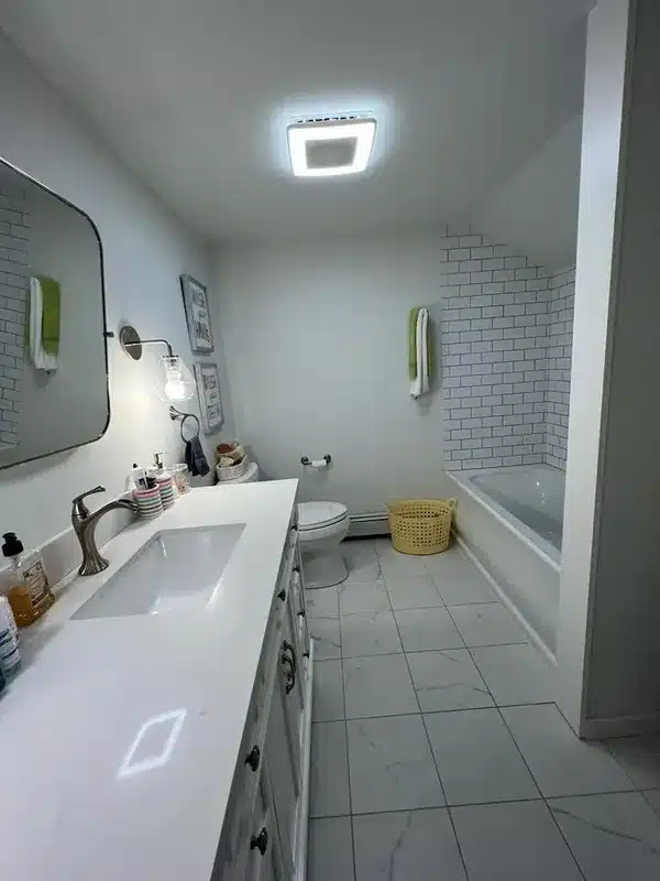 The same bathroom after cleaning: clear vanity, clean floor and tub, Glastonbury, CT