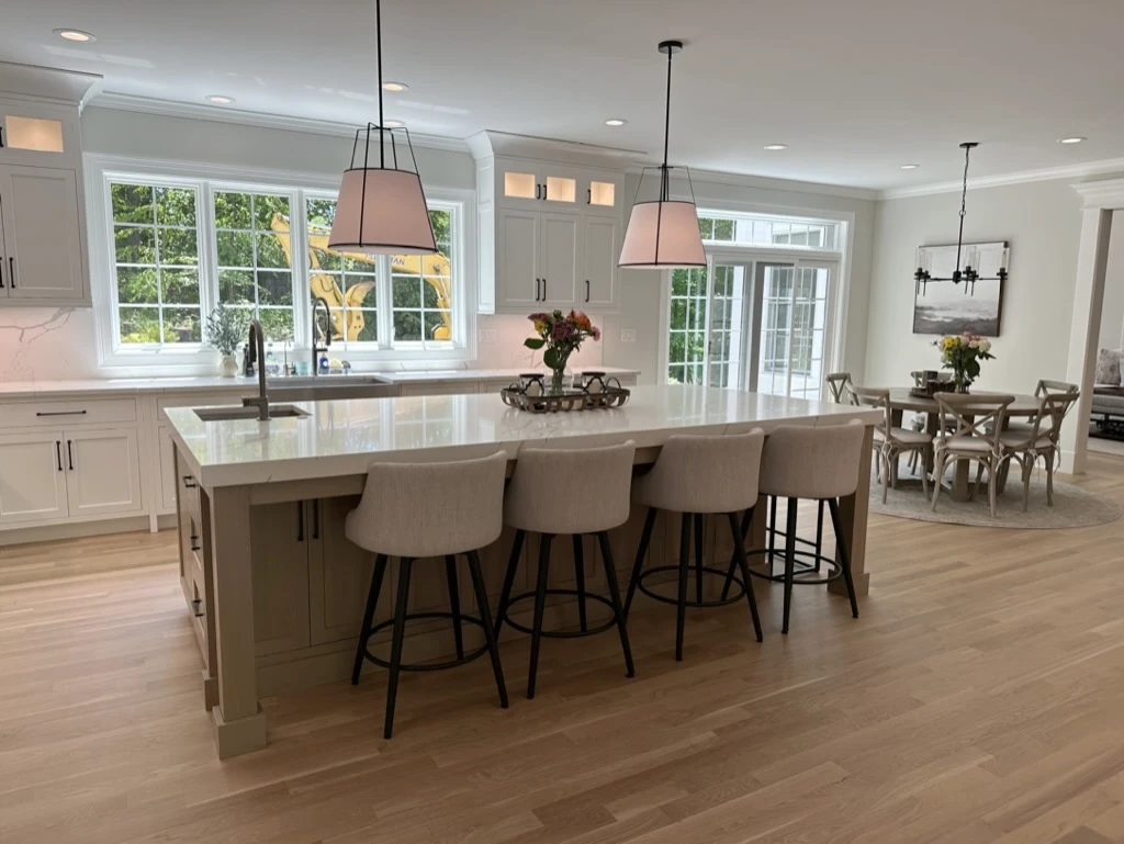 Bright kitchen with a large island and pendant lights in a home cleaned by Family Cleaners
