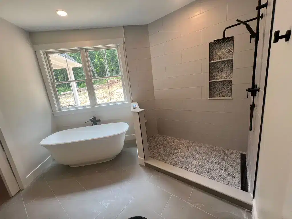 A finished new bathroom with a freestanding tub and a tiled walk-in shower