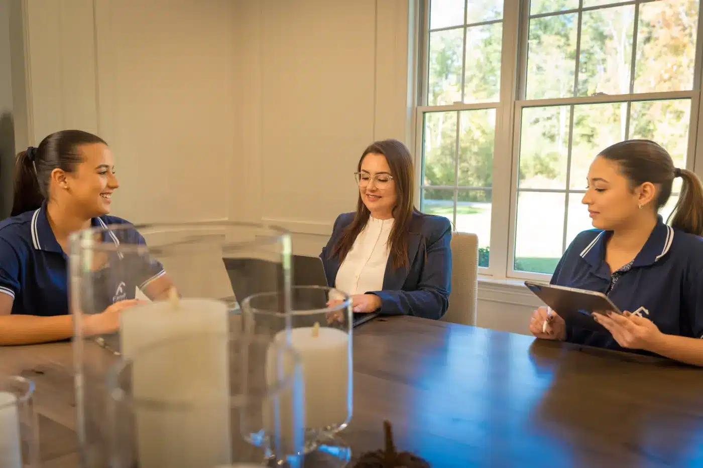 Airbnb Cleaning 5 CEO Caroline Compiani at a table with two Family Cleaners team members