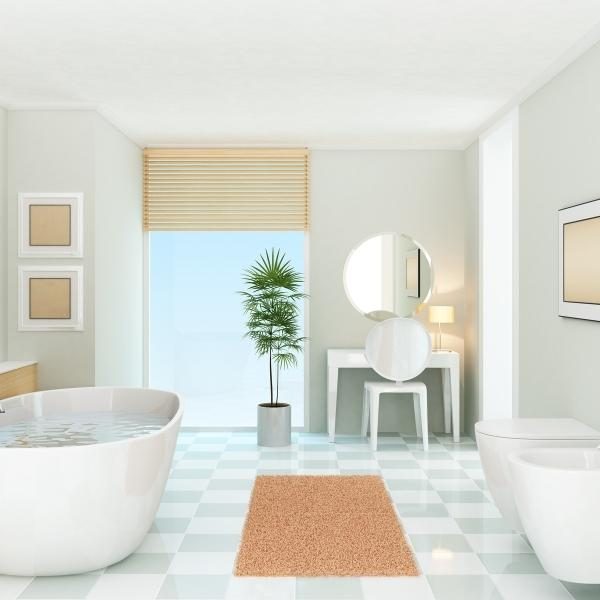 A clean bathroom featuring a freestanding tub and a potted plant.