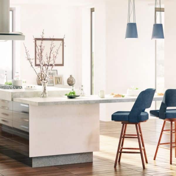 A modern kitchen featuring a stone island and comfortable blue barstools.